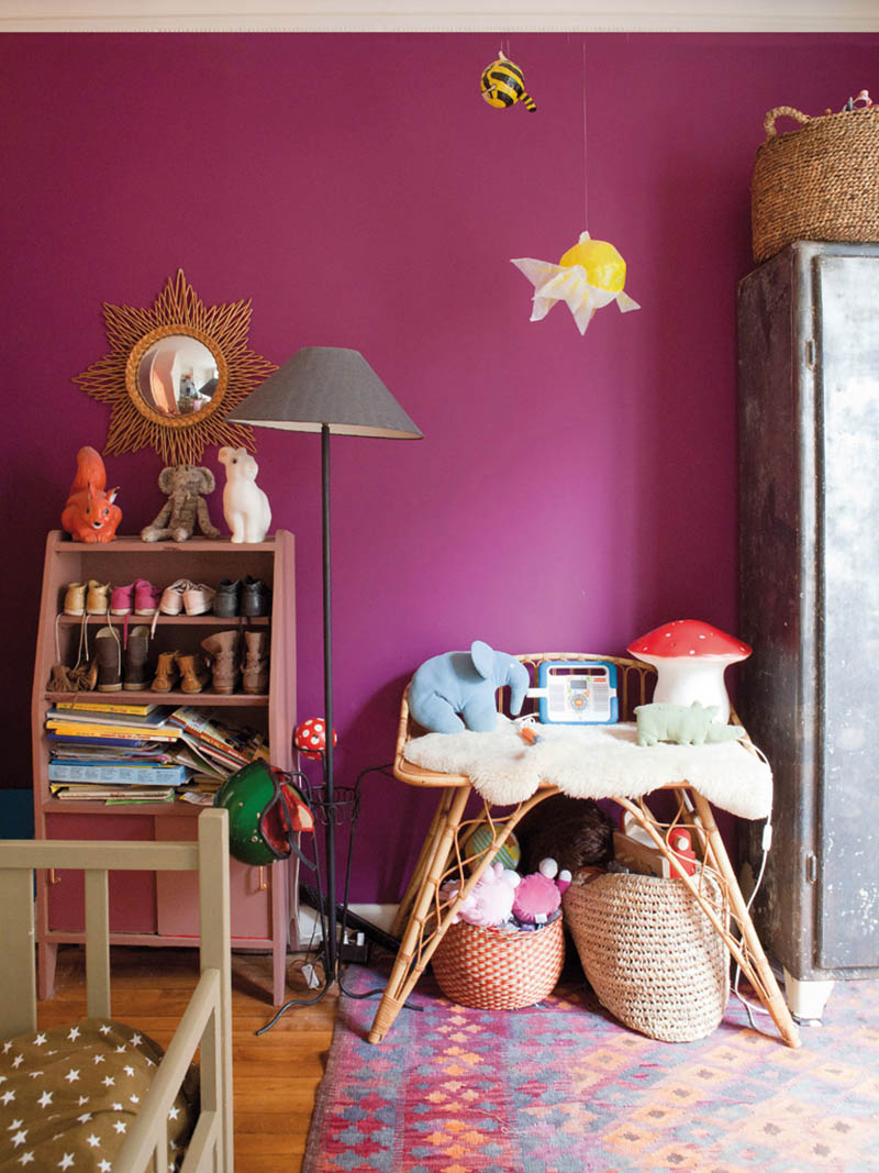 Une chambre d'enfant aux murs fuchsia en mode bazar chic