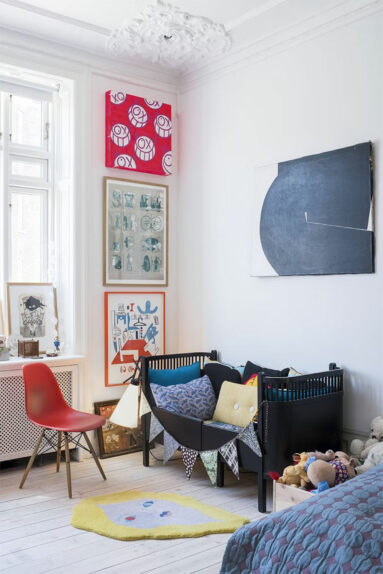 Une chambre de bébé blanche avec des accents de couleurs