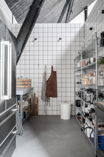 Une cuisine de style industriel en noir et blanc, dans la grande pièce ouverte