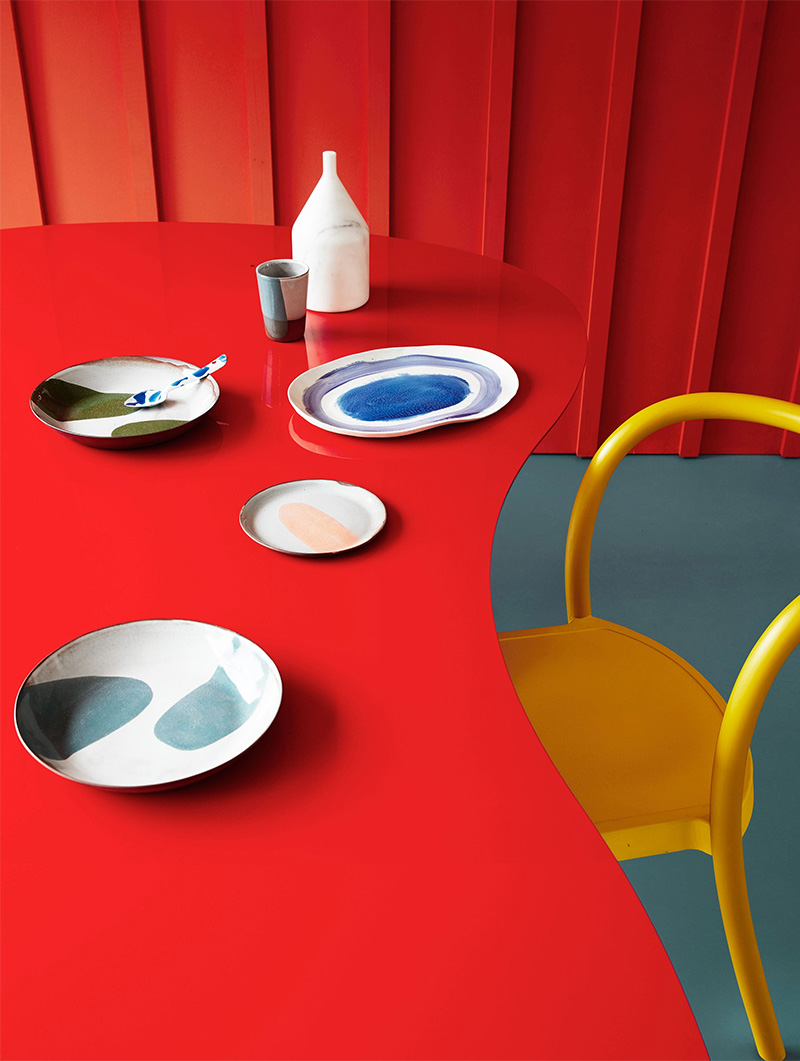 table rouge, mur en lambris rouge et chaine jaune