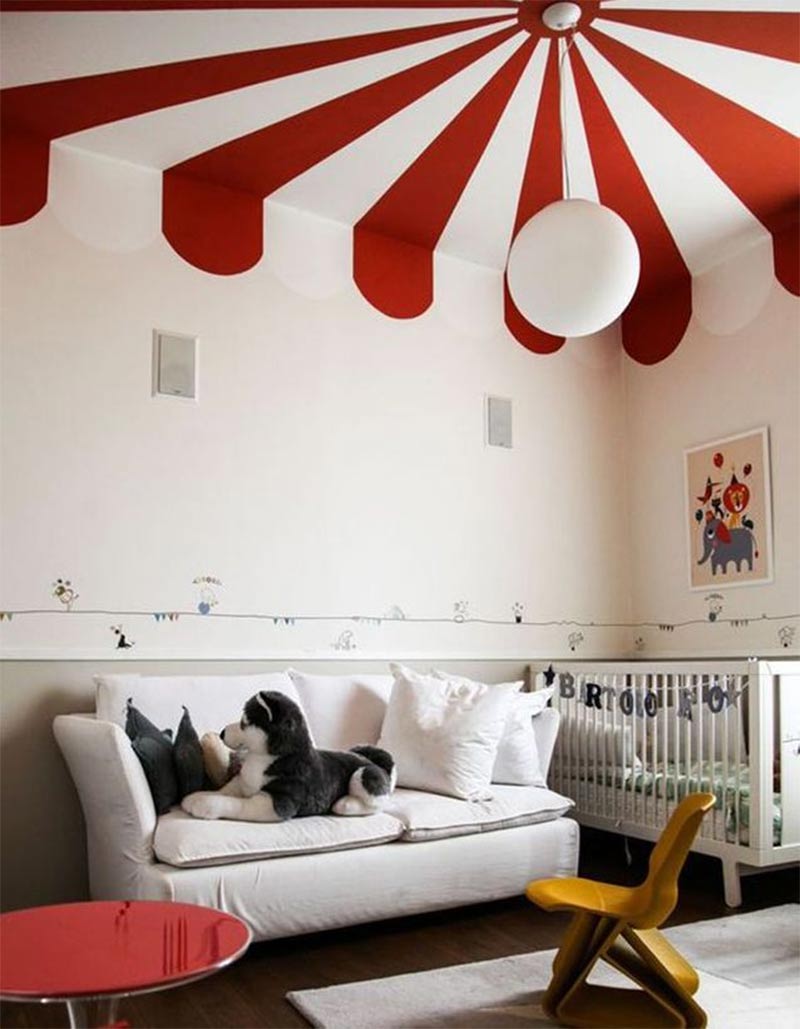 Une chambre d'enfant avec un plafond peint, façon châpiteau de cirque