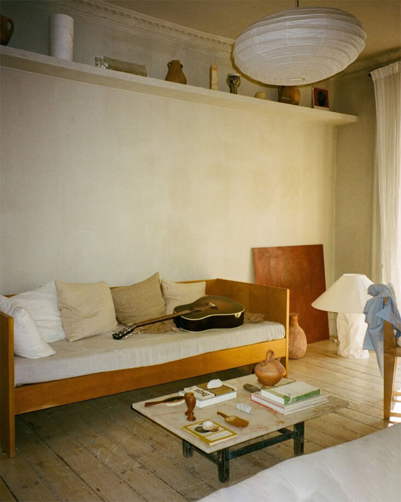 L'appartement-galerie d'Aarticles : Le salon avec son canapé banquette, décoré d'objets design 